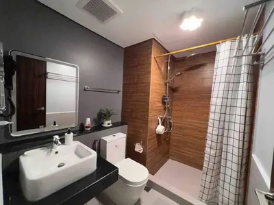 a bathroom with a sink and a toilet and a shower at The Radiance Manila Bay - Modern 1-Bedroom Condo with View in Manila