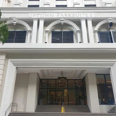 a building with the entrance to the uptown park services at Cozy 1BR UPTOWN PARKSUITES Tower1 BGC in Manila