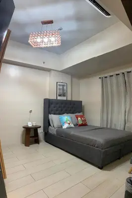 a bedroom with a large bed in a room at Salamat Place Original in Manila