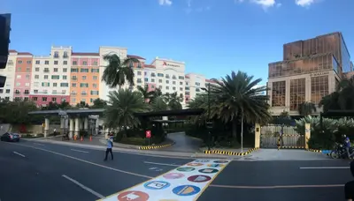 a person walking down a street in a city at Salamat Place Original in Manila