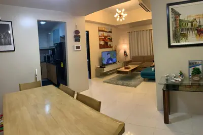 a living room with a dining table and a living room at Salamat Place Original in Manila