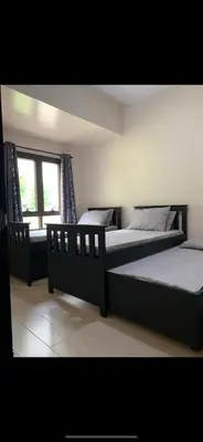 a bedroom with two beds and a window at Salamat Place Original in Manila