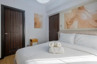 a bedroom with a white bed with towels on it at The Radiance Manila Bay in Manila