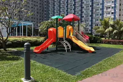 a playground with a slide in a park at Jazz Residences (Destina Stays)Makati, Metro Manila in Manila