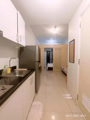 a kitchen with white cabinets and a sink at Jazz Residences (Destina Stays)Makati, Metro Manila in Manila