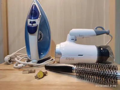 a hair dryer sitting on top of a wooden table at Netflix, Destina Stays at Jazz Residences Makati, MetroManila in Manila