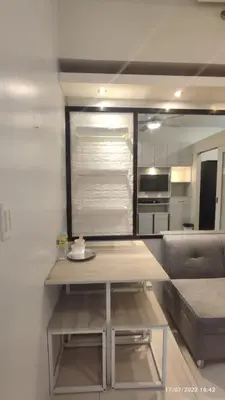 a living room with a table and a couch at Netflix, Destina Stays at Jazz Residences Makati, MetroManila in Manila