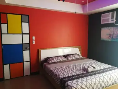 a bedroom with a bed and a colorful wall at Cubao Manhattan Heights Unit 11PQ Tower B, 1BR in Manila