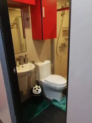 a bathroom with a toilet and a soccer ball on the floor at Cubao Manhattan Heights Unit 11PQ Tower B, 1BR in Manila