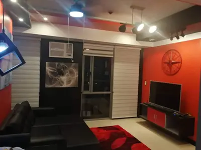 a living room with a couch and a television at Cubao Manhattan Heights Unit 11PQ Tower B, 1BR in Manila