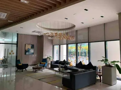 a large living room with a large chandelier at Studio at viceroy t4 Florence way in Manila