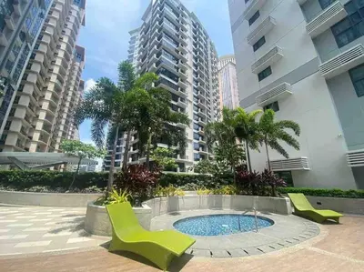 a patio with chairs and a pool in the middle of some buildings at Studio at viceroy t4 Florence way in Manila