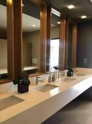 a bathroom with three sinks and a large mirror at Studio at viceroy t4 Florence way in Manila