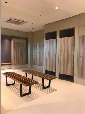 a room with two wooden benches in a room at Studio at viceroy t4 Florence way in Manila