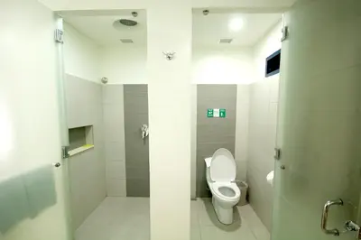a bathroom with a toilet and a shower at Go Hotels Otis - Manila in Manila