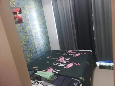 a bedroom with a bed with pink flamingos on it at Alatonplace sea residences in Manila