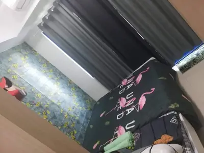 a bedroom with a bed with two pillows on it at Alatonplace sea residences in Manila