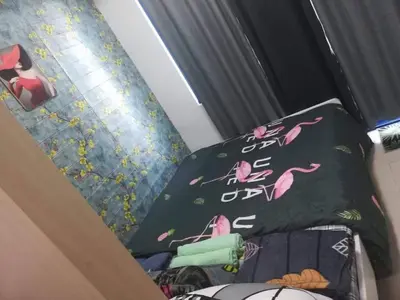 a bed with two pillows with pink flamingos on it at Alatonplace sea residences in Manila