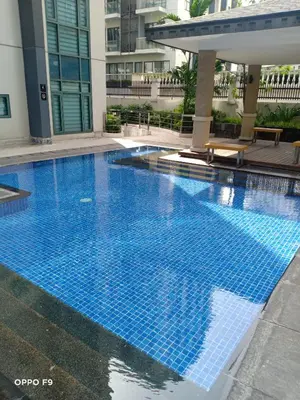 a large blue swimming pool in a building at MRMCONDOTEL cluster 1 2H in Manila