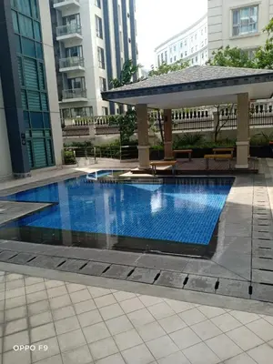a swimming pool in a building with a gazebo at MRMCONDOTEL in Manila