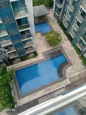 an overhead view of two swimming pools in front of buildings at MRMCONDOTEL in Manila