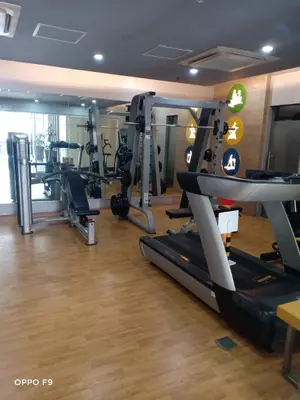 a gym with treadmills and machines in a room at MRMCONDOTEL in Manila