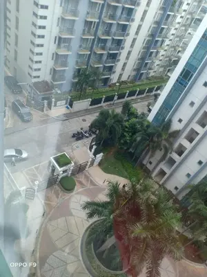 a view of a city with palm trees and buildings at MRMCONDOTEL in Manila
