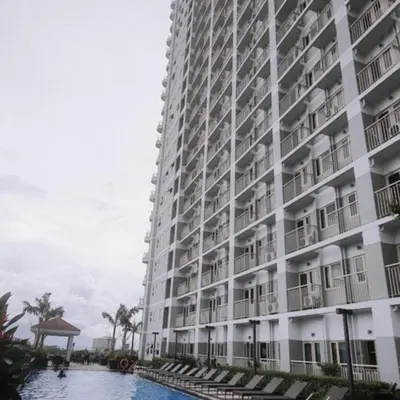 a large building with a pool in front of it at SMDC Coast Residences Lovely Fully-furnished 1 BR Condo with pool in Manila