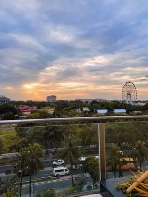 a view of a city with a ferris wheel in the distance at SMDC Coast Residences Lovely Fully-furnished 1 BR Condo with pool in Manila