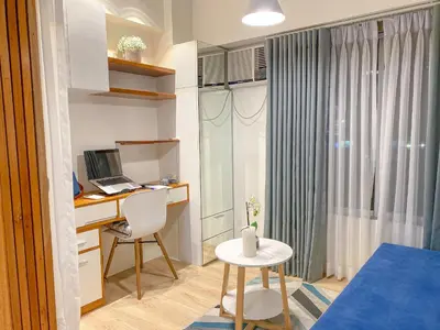 a room with a desk with a computer and a chair at Large 1-Bedroom Condo 60sqm Makati Rockwell CBD Poblacion in Manila