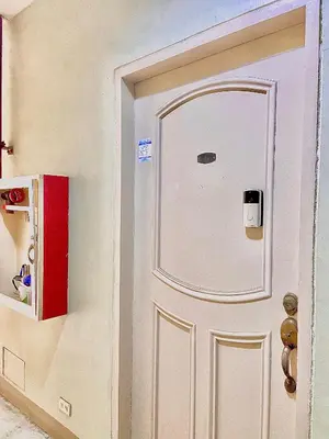 a white door with a window on a wall at IV’s Condo w/ Netflix, Wifi & Karaoke in Cainta