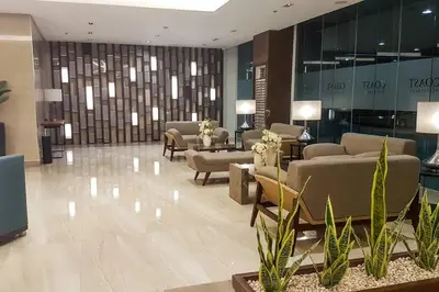 a lobby with couches and chairs in a building at StayInMyCondo - 8th Condo in Pasay near NAIA Airport, MOA Pasay in Manila