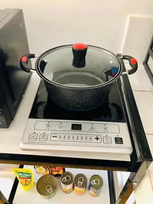 a pot sitting on top of a stove at Avida Tower Sucat, comfortable studio type in Manila