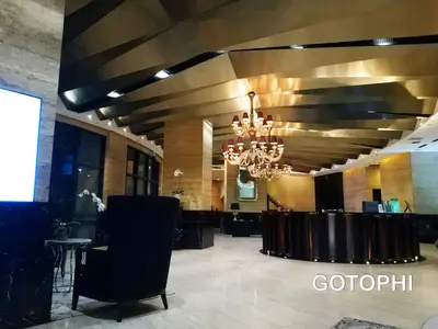 a lobby with a chandelier and a table and chairs at the Gramercy Residences NEW RELEASE in Manila