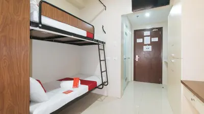 a bedroom with two bunk beds in a room at RedDoorz Plus near Nakpil St Taft Avenue in Manila