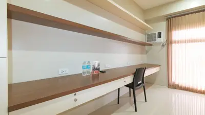 a kitchen with a wooden desk and a chair at RedDoorz Plus near Nakpil St Taft Avenue in Manila