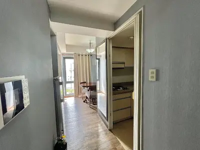 a hallway with a door to a room with a table at CEO Flats in Manila
