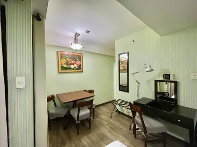 a living room with a desk and a table and a desk at CEO Flats in Manila