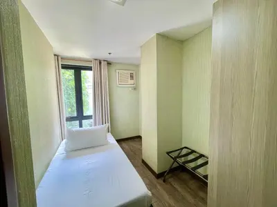 a small room with a bed and a window at CEO Flats in Manila