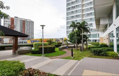 a park in the middle of a city with buildings at Beacon Makati Condo Free POOL Access FREE WIFI 100mbps & FREE Netflix in Manila