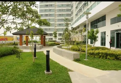 a park in front of a large building at Beacon Makati Condo Free POOL Access FREE WIFI 100mbps & FREE Netflix in Manila