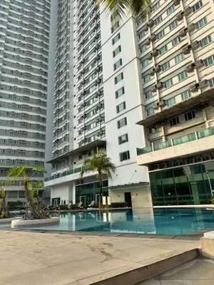 a swimming pool in front of tall buildings at Beacon Makati Condo Free POOL Access FREE WIFI 100mbps & FREE Netflix in Manila