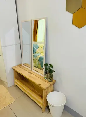a mirror sitting on a wooden table next to a toilet at Beacon Makati Condo Free POOL Access FREE WIFI 100mbps & FREE Netflix in Manila