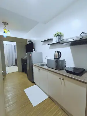 a kitchen with a counter top and a refrigerator at Ethan's Pad Nr. BGC in Manila