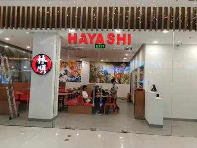 a restaurant in a shopping mall with people sitting at tables at Ethan's Pad Nr. BGC in Manila