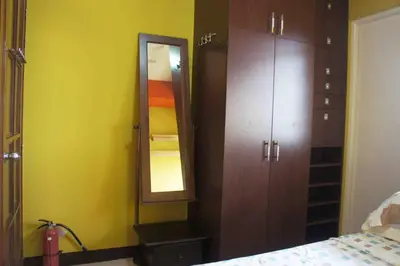 a bedroom with a mirror and a closet and a bed at BalaiB1 Cozy Studio in Ortigas Center in front of Galleria in Manila