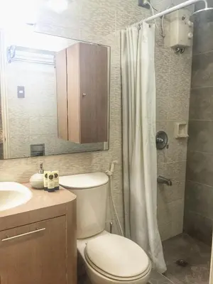 a bathroom with a toilet and a sink and a shower at BalaiB1 Cozy Studio in Ortigas Center in front of Galleria in Manila
