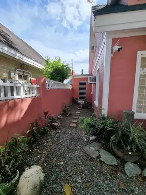 a red house with a walkway next to a building at #30 Bel Air House by Red Door House Rental in Santa Rosa