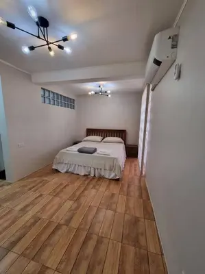 a bedroom with a bed and a wooden floor at #30 Bel Air House by Red Door House Rental in Santa Rosa