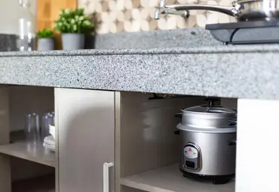 a kitchen counter with a pot under a sink at Hive Manila Guesthouse -Netflix,400mbps WI-FI in Bacoor